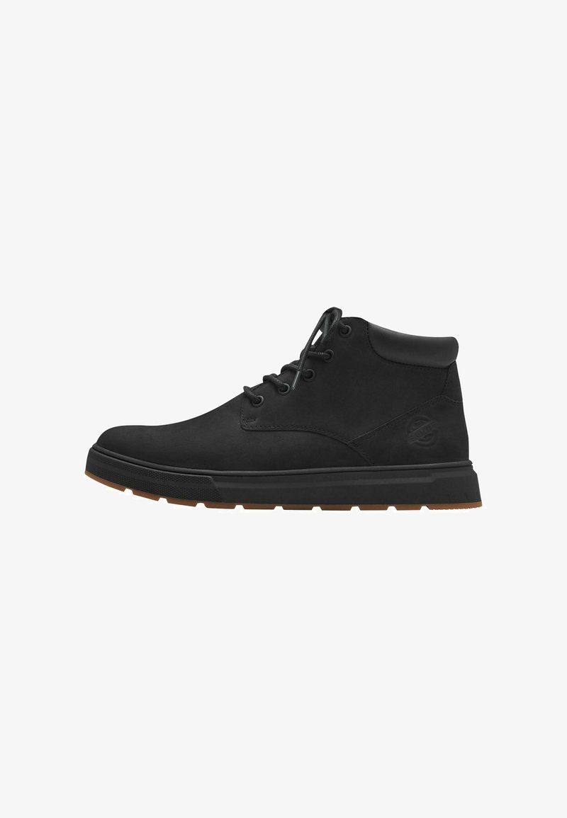 Black leather ankle boots with round toe, lace-up design, and rubber sole featuring a brown tread for traction; logo embossed on side.