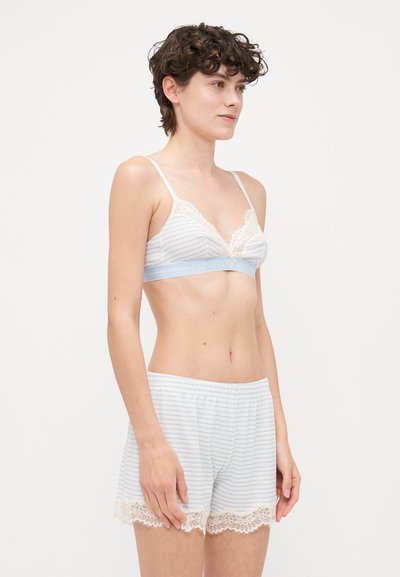 Striped bralette and shorts set in light blue and white. Lace trim on bralette and shorts. Soft cotton fabric. Elastic waistband.