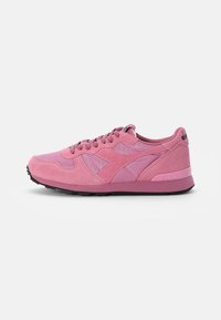 Pink athletic sneaker featuring a mix of suede and mesh uppers, round toe, padded collar, and a black rubber outsole.