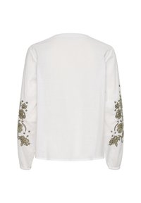 Camicia bianca a maniche lunghe con ricami floreali verdi lungo le maniche. La trama sembra leggermente tessuta e liscia.