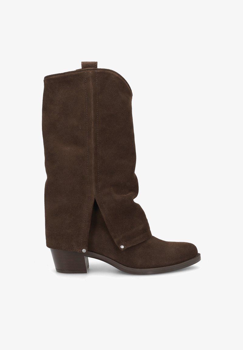 Brown suede ankle boots with a slouch design, low block heel, and snap button accents. Features a rounded toe and soft texture.