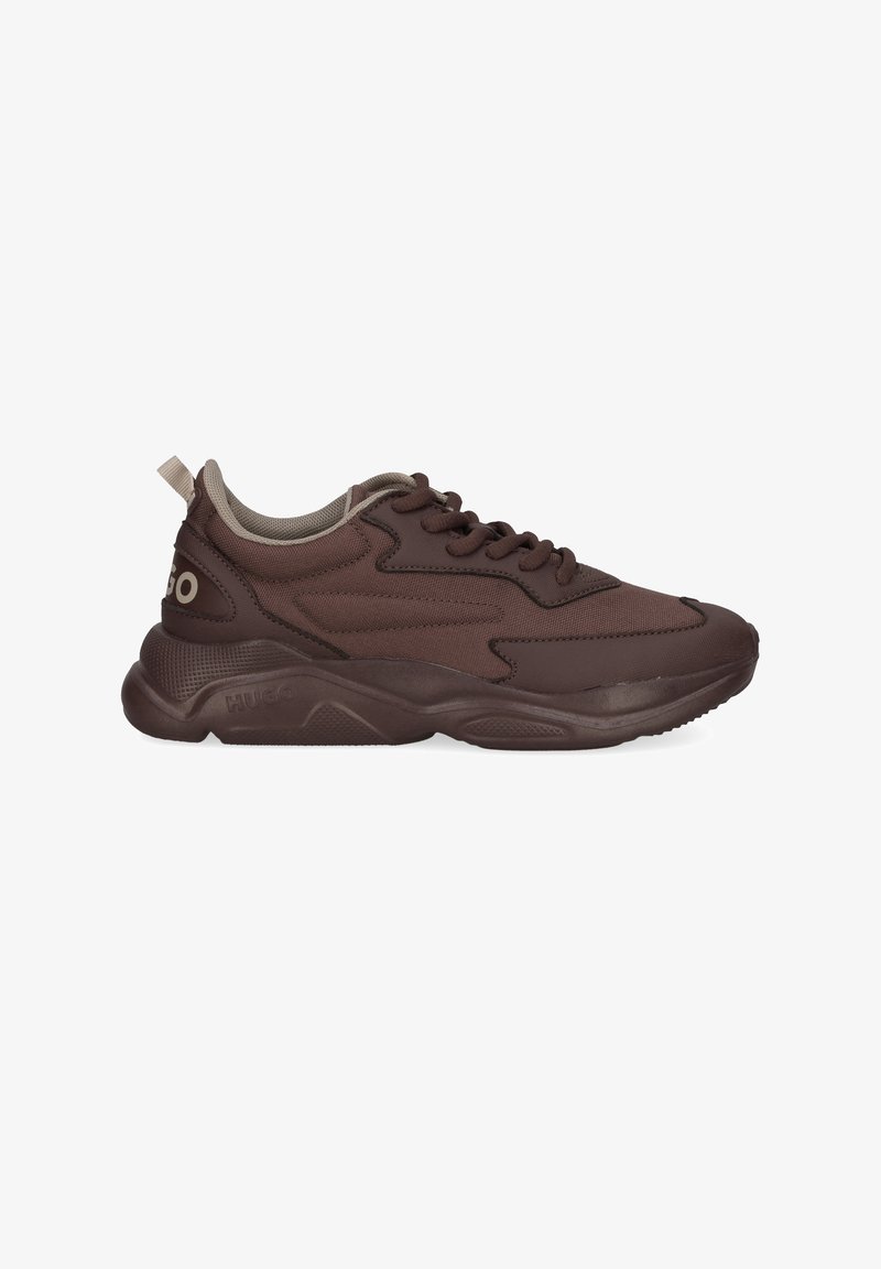 Brown athletic shoes made of textile with a thick rubber sole, featuring a lace-up design, rounded toe, and subtle branding on the side.