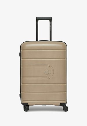 Hard-shell suitcase in metallic gold with textured finish, black telescopic handle and wheels, featuring subtle ridges and a logo emblem.