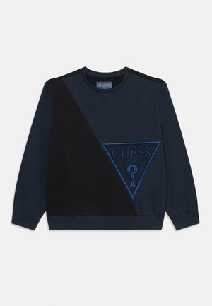 Sweat-shirt bleu marine avec un panneau noir contrastant, grand logo triangulaire avec des coutures bleues, col et poignets côtelés.