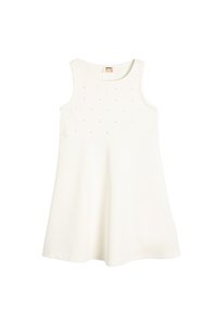 Vestido blanco sin mangas con una falda acampanada, hecho de una tela suave. El corpiño presenta pequeños y sutiles puntos decorativos.