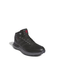 Black high-top shoe made of leather with synthetic accents. Features textured panels, grey speckled sole, and red branding detail.