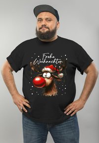 Black t-shirt featuring a cartoon reindeer with a red nose and Santa hat, adorned with white snowflakes and the text "Frohe Weihnachten."