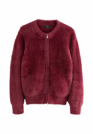 Burgundi faux karvanepp, ringikujulise kaelusega, esise zipper-kinnitusega ja kahe küljetaskuga. Omab tekstuurset, karvast pindala.