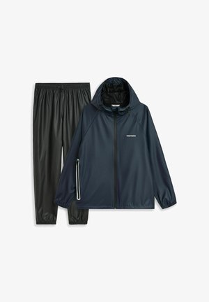 Navy waterproof jacket with adjustable hood and zippered pockets, paired with black elastic-waist pants. Smooth texture, lightweight material.