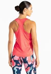 Rotes sportliches Tanktop mit Racerback-Design, kombiniert mit gemusterten Leggings, die abstrakte Formen in Pink, Marineblau und Türkis zeigen.