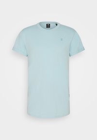 Ljusblå kortärmad t-shirt i bomull med rundad hals och uppvikta ärmar, med en liten logotyp framtill.