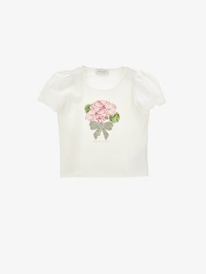 Chemise blanche à manches courtes bouffantes, avec un bouquet de fleurs roses et un nœud à pois imprimés au centre devant.