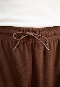 Rains ADDIS PANTS WIDE UNISEX - Tepláky - frame