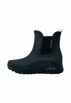 Bottes chelsea noires imperméables avec un extérieur en caoutchouc lisse, un bout arrondi, des panneaux latéraux élastiques et une semelle à coussin d'air.