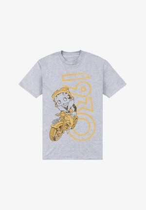 Grå T-shirt med korte ærmer, prydet med et gult vintage motorcykelmotiv med en tegneseriefigur og teksten "1960." Materialet er en bomuldsblanding.