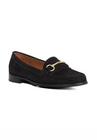 Black suede loafers with a gold decorative hardware detail across the front, stitched accents, and a low black sole.