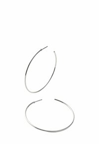 Pendientes de aro plateados, finos y circulares, con una superficie lisa y un diseño minimalista. El cierre de alambre es visible en la parte superior.