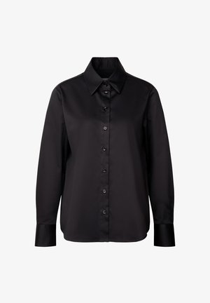 Maglietta nera a maniche lunghe in tessuto liscio con colletto classico e chiusura frontale con bottoni. Presenta bottoni neri e polsini aderenti.