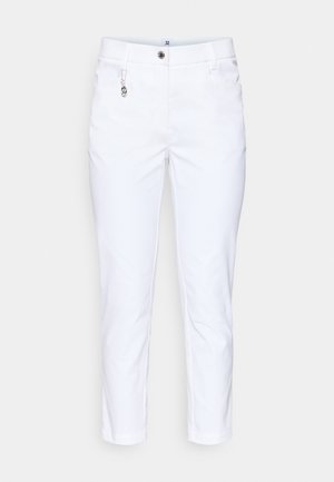 White cropped trousers made of smooth fabric, featuring a front button, side pockets, and a decorative silver charm on a belt loop.