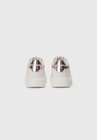 White sneakers with metallic pink accents, round toe, and textured surface, featuring a logo on the heel and smooth rubber sole.