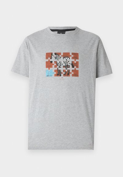 T-shirt gris à manches courtes avec un graphique de zèbre multicolore sur un fond de pièces de puzzle avec un accent bleu. Coupe standard, en coton.