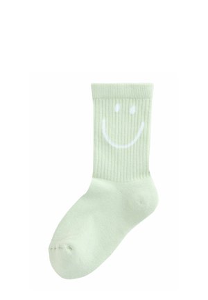 Ljusgrön ribbad strumpa med ett vitt smiley-ansikte på ovansidan. Mjuk textur med standardlängd för crew-strumpor.