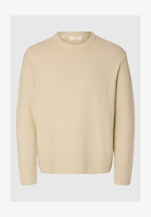 Cream-colored sweater made of textured fabric. Features a ribbed round neckline and ribbed cuffs, with a relaxed fit and long sleeves.