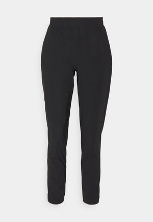 Zwarte taps toelopende broek met een elastische tailleband, gemaakt van een gladde, lichtgewicht stof. Voorzien van zijzakken en een gestroomlijnd silhouet.
