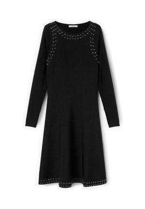 Schwarzes Kleid mit langen Ärmeln und ausgestelltem Saum, verziert mit Nieten an den Schultern und am Saum. Hergestellt aus weichem, elastischem Stoff.