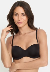 Zwart naadloze onderwire-bh met gladde cups, verstelbare bandjes en een klein decoratief detail in het midden. Zachte stofstructuur.