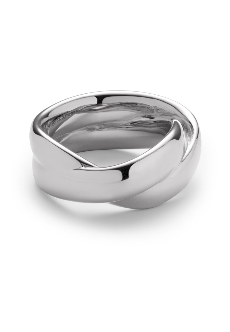 Bague en métal argenté avec un design tordu, présentant une surface lisse et polie ainsi que des bords arrondis. La forme crée un aspect fluide et continu.