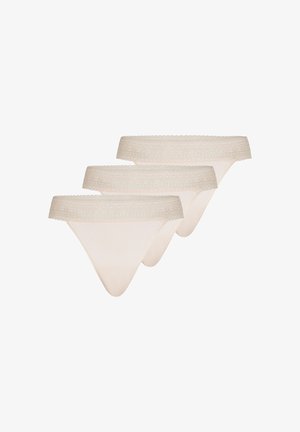 Three beige lace-trimmed women's thong underwear pieces, arranged in a staggered overlapping row on a white background.
