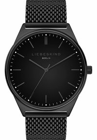 Zwarte mesh horloge met een minimalistische zwarte wijzerplaat. Bevat dunne uurmarkeringen en zilveren accenten. Strakke ronde kastontwerp.