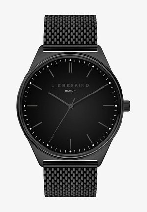 Sort mesh remwatch med en minimalistisk sort urskive. Har tynde time-markeringer og sølvdetaljer. Slank rundt kassedesign.