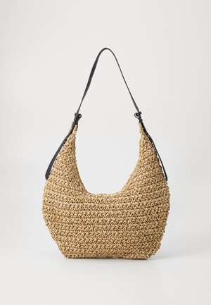 Woven straw handbag with a rounded silhouette, featuring a black leather shoulder strap. Textured, natural finish, and lightweight design.