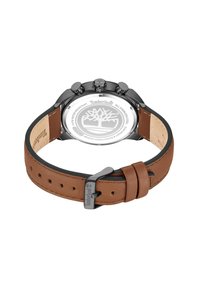 Montre avec bracelet en cuir brun et dos en acier inoxydable, dotée d'un boîtier noir et du logo Timberland gravé. Comprend trois boutons-poussoirs sur le côté.