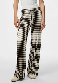 Pantalons à rayures, à jambe large, en noir et crème, fabriqués en tissu doux. Présentent une taille élastique à cordon de serrage ajustable et une coupe confortable.
