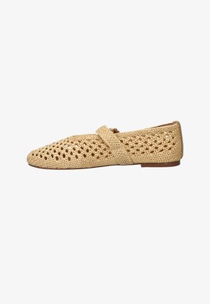 Beige woven flat shoe with a strap across the top and a low heel, featuring an open lattice design for breathability.
