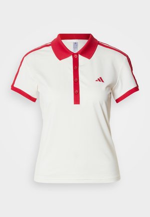 Bílá polokošile s červeným límcem a manžetami, se zapínáním na knoflíky a červenými pruhy po stranách. Na prsou je malý červený nápis.