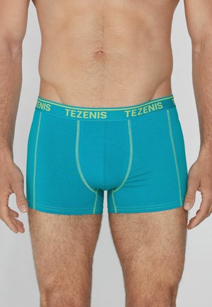 Türkise Herren-Boxershorts mit einem gelben "TEZENIS"-Bund. Glattes, elastisches Gewebe mit kontrastierenden Nähten.
