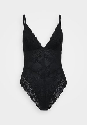 Bodysuit en dentelle noire avec un décolleté plongeant en V, des bretelles ajustables, des motifs floraux et des bordures festonnées le long de l'encolure et des ouvertures des jambes.