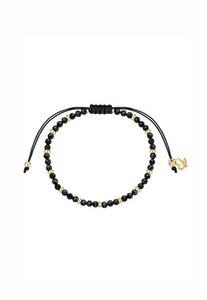 Zwart kralenarmband met kleine gouden kralen en een verstelbare zwarte koord, eindigend met een gouden lotus bedel.