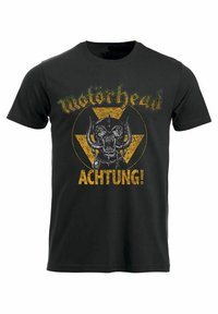 Camiseta de algodón negra con cuello redondo que presenta un gráfico de triángulo amarillo, un logo de calavera y el texto "Motörhead" y "ACHTUNG!" en negrita.