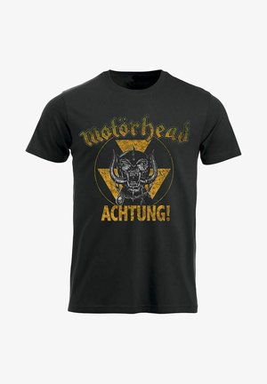 Svart bomull t-skjorte med rund hals som har et gult trekantsgrafikk, et hodeskallelogo, og teksten "Motörhead" og "ACHTUNG!" med fet skrift.