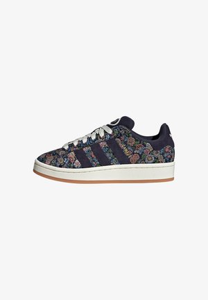 Navy floral-patterned sneaker with three dark stripes, white rubber sole, fabric upper, and silver laces. Features padded collar and logo accents.
