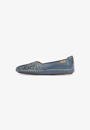 Flat shoe in blue leather with cut-out floral design, beige stitching along the edges, rounded toe, and a textured accent at the heel.
