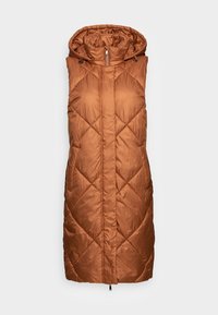 Pitkä, hupullinen toppaliivi ruosteenoranssissa, jossa on tikattu kuviointia vinoneliömäisesti ja edessä vetoketjusuljin. Sileä, kiiltävä pinta.