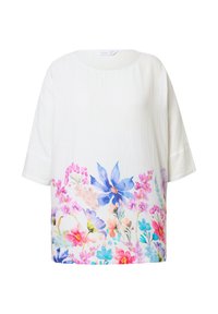 Top bianco a maniche corte in tessuto leggero, caratterizzato da un vivace motivo floreale nei toni del rosa, blu e viola nella parte inferiore.