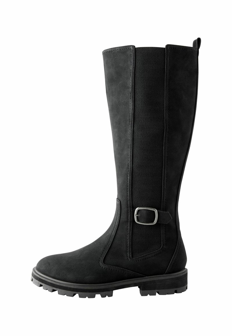Black knee-high boots made of soft suede with elastic side panels, a metal buckle accent, and a rugged rubber sole. Flat heel design.