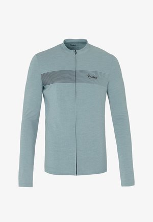 Svijetloplava jakna dugih rukava s patentnim zatvaračem, s teksturiranim uzorkom i crnom vodoravnom prugom preko prsnog dijela. Ima okrugli ovratnik.